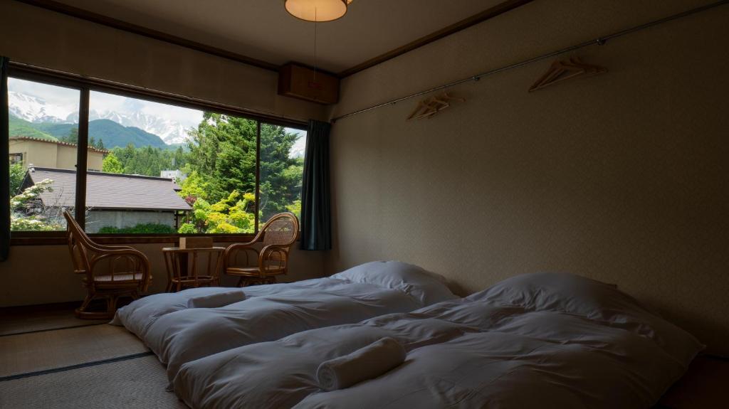 Postel nebo postele na pokoji v ubytování Hakuba Hospitality Inn YUKINOSO