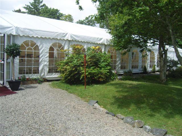 a white building with a tent in a yard at Errisbeg House B&B in Roundstone