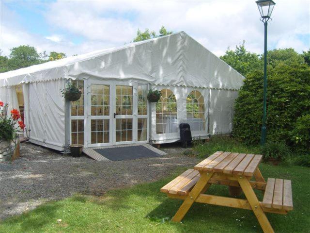 a tent with a picnic table in front of it at Errisbeg House B&B in Roundstone