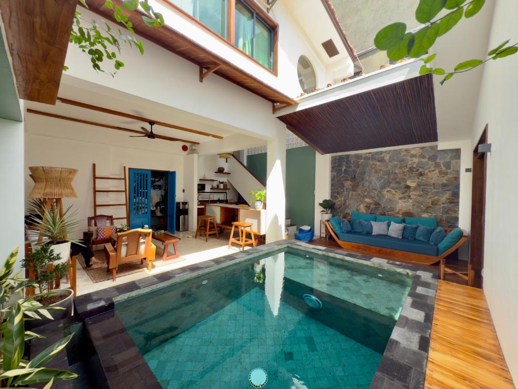 a house with a swimming pool in a living room at Lugadia Villas in El Nido