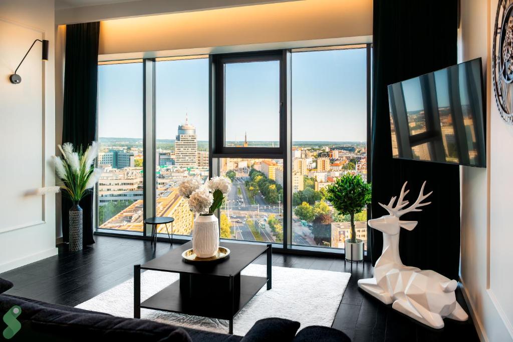 a living room with a view of the city at HANZA Black & White 17th floor SPA & Pool Free Parking by Stayly in Szczecin
