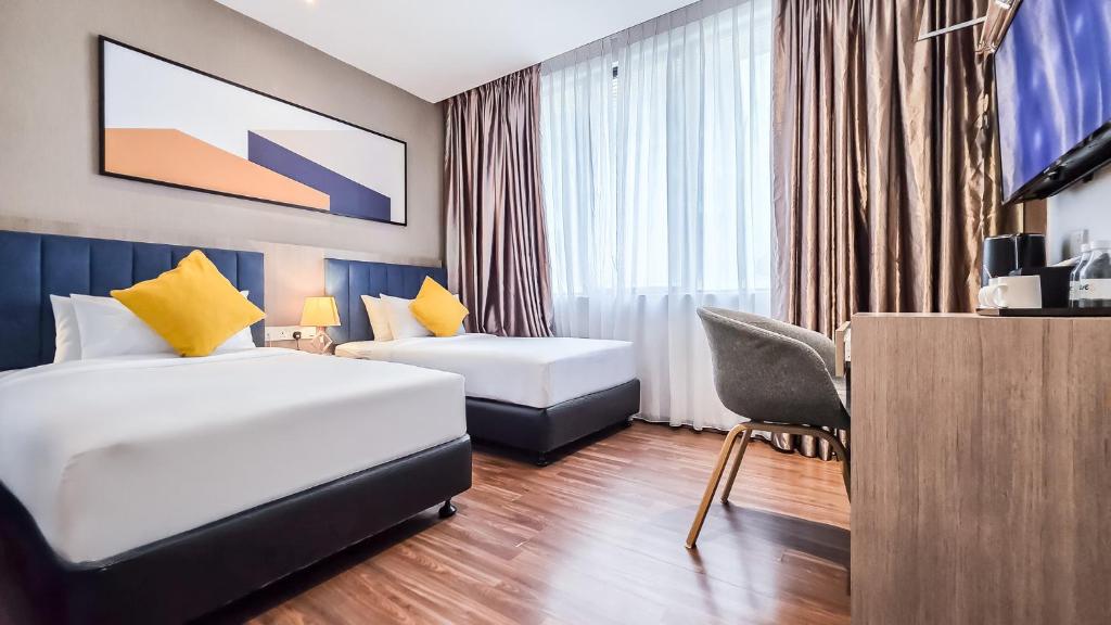 Postel nebo postele na pokoji v ubytování Fives Hotel Johor Bahru City Centre