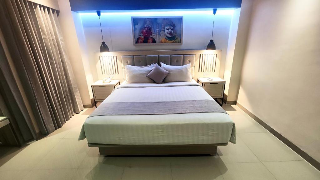 Postel nebo postele na pokoji v ubytování 1O1 URBAN Jakarta Thamrin