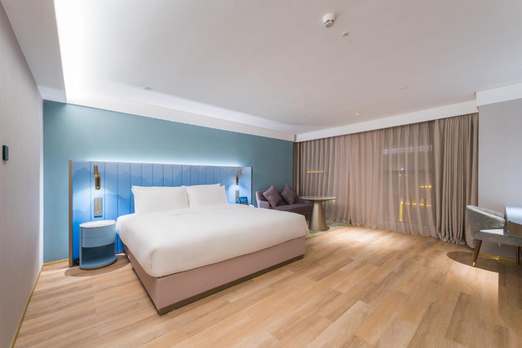 Postel nebo postele na pokoji v ubytování Manxin Hotel Guangzhou Baiyun Airport Branch
