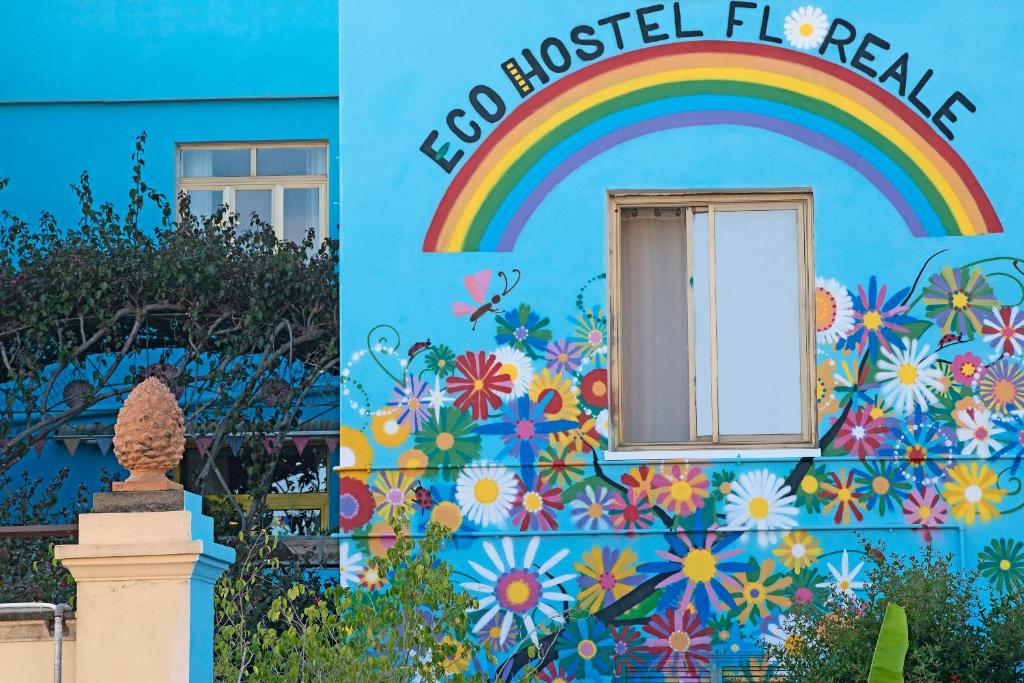 a colorful building with a rainbow and a window at Eco hostel floreale in Ercolano