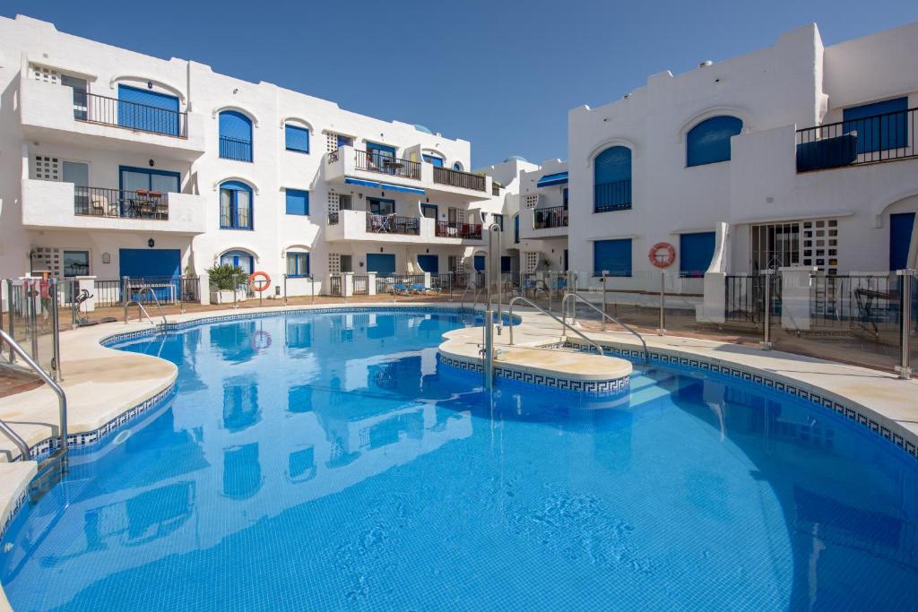 a large swimming pool in front of a building at Brisa del Puerto de la Duquesa in Manilva