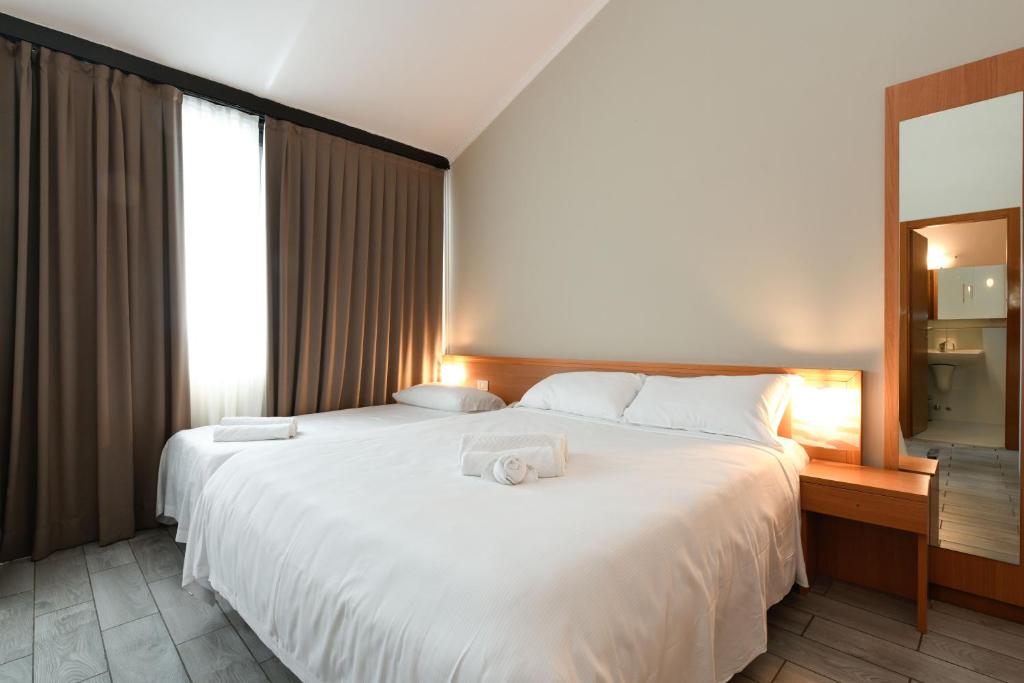 Postel nebo postele na pokoji v ubytování Hotel Garda