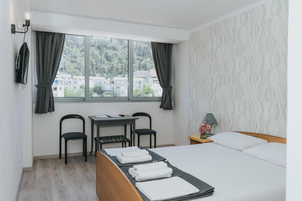 Postel nebo postele na pokoji v ubytování Hotel Tolero