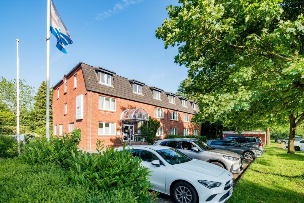 a group of cars parked in front of a building at Hotel an der Schlei Garni in Fahrdorf