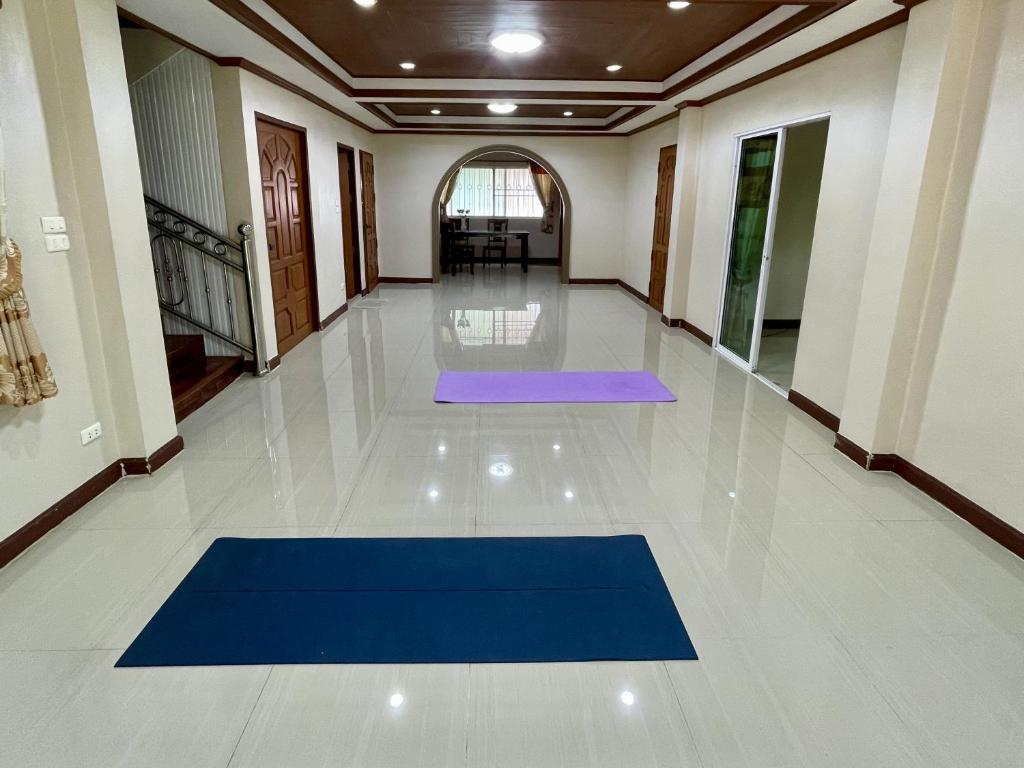 a hallway with a blue yoga mat on the floor at Yoga Bed and Breakfast in Chiang Mai