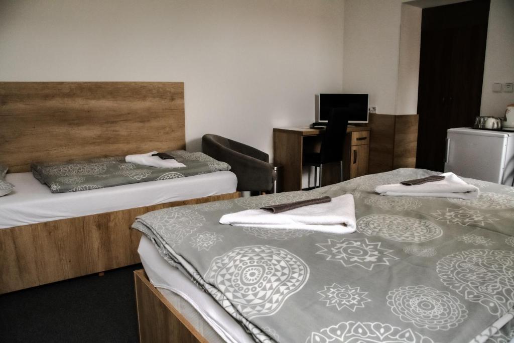 Postel nebo postele na pokoji v ubytování Penzion Kometa - rodinný pobyt u Novomlýnských jezer s komfortem, restaurací a dětskou zónou