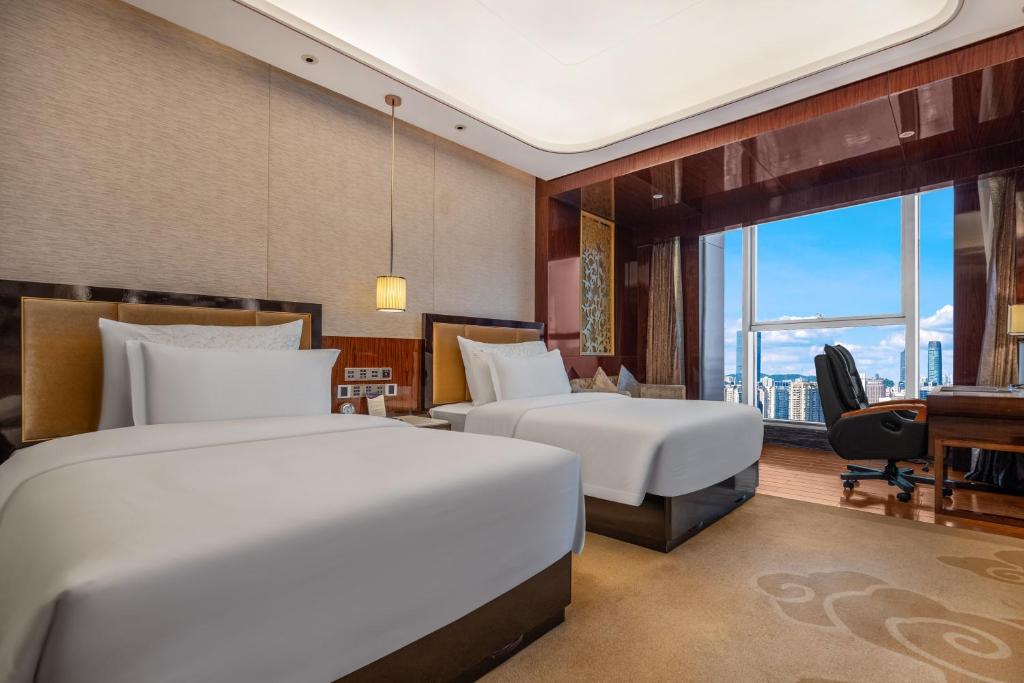Postel nebo postele na pokoji v ubytování Chengdu CYNN Hotel