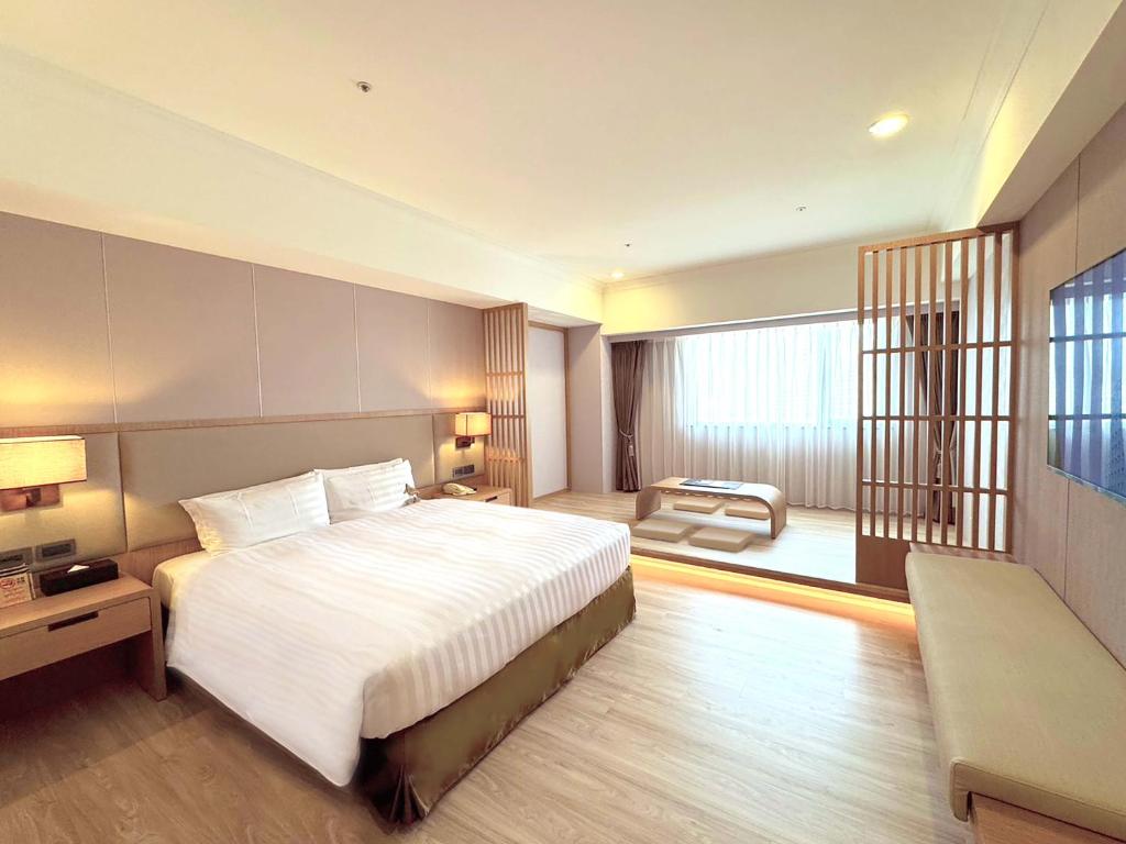 Postel nebo postele na pokoji v ubytování Fushin Hotel - Tainan