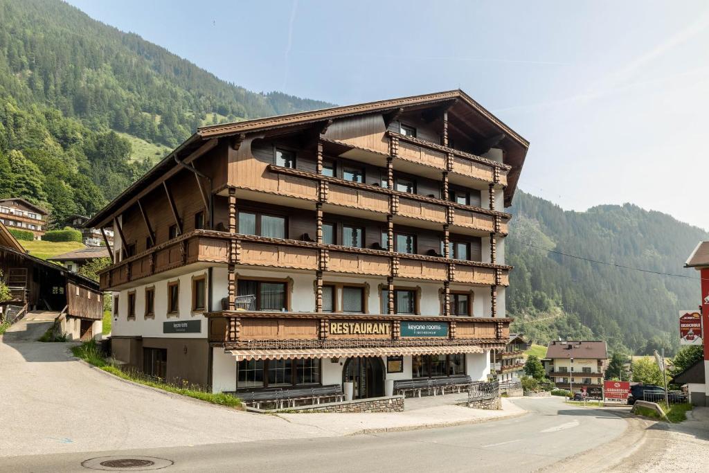 a large building on the side of a mountain at keyone rooms Finkenberg in Finkenberg