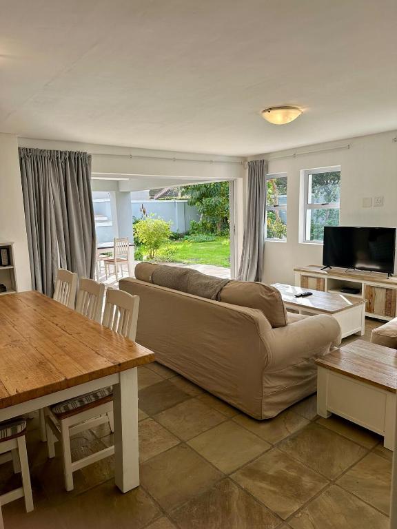 a living room with a couch and a table at Myrtle 3 Bed House in Tokai
