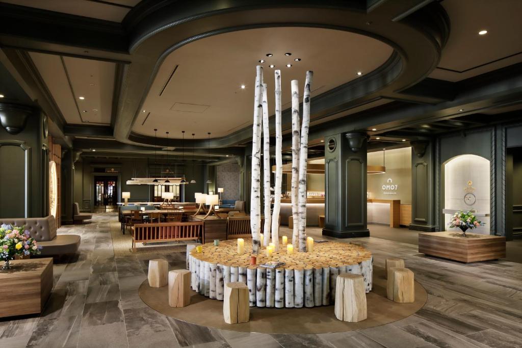 a lobby of a hotel with a table with candles at OMO7 Asahikawa by Hoshino Resorts in Asahikawa