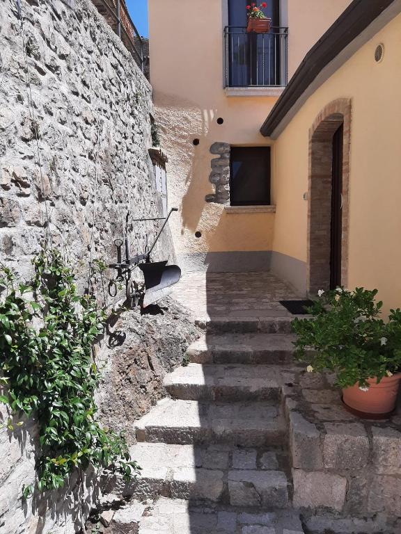 a stone stairway leading up to a building at La Costa Del Sole in San Fele