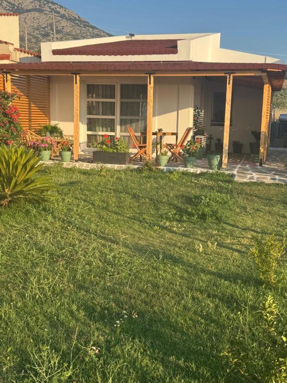 a house with a lawn in front of it at Ana Maria Boutique House in Samothraki