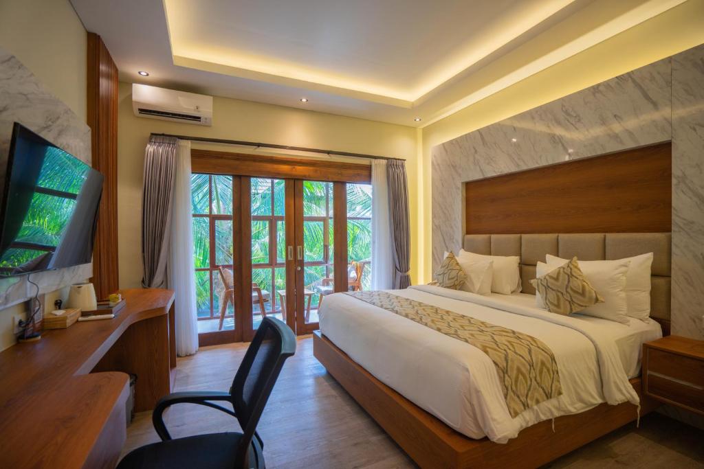 Postel nebo postele na pokoji v ubytování The Grand Villandra Resort Lovina