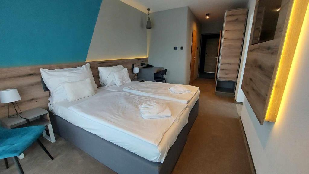 Postel nebo postele na pokoji v ubytování Hotel Szieszta
