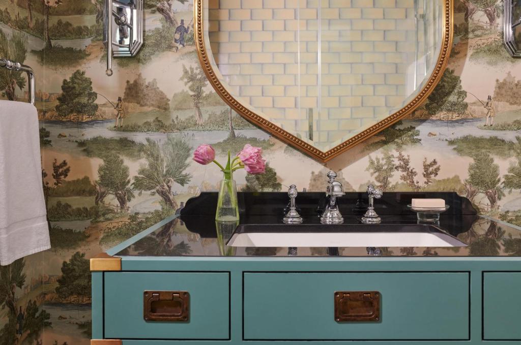 a bathroom with a sink and a mirror at Graduate by Hilton Cambridge in Cambridge