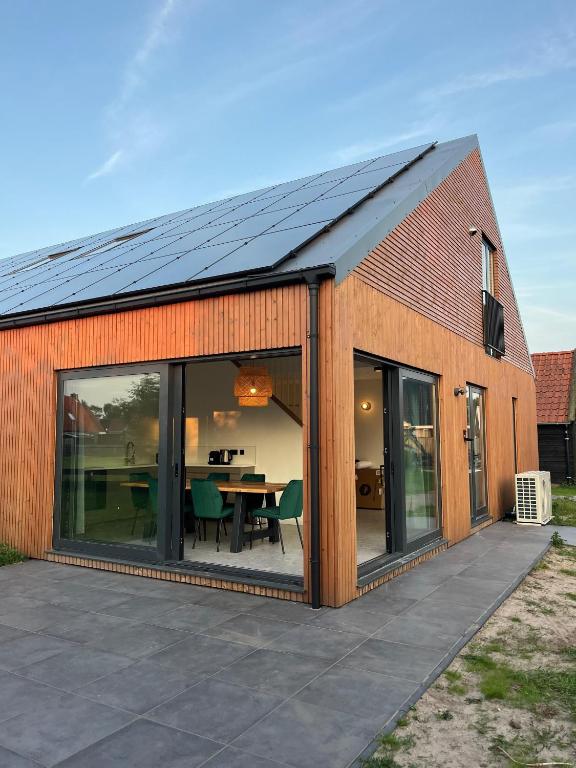 an extension to a house with sliding glass doors at Tussen Dijken in Hollum