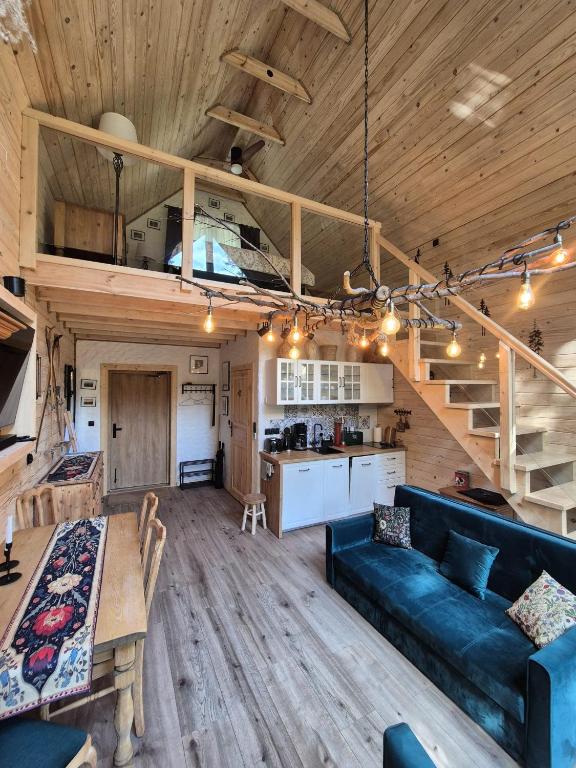 a living room and kitchen with a couch and a table at Woodland House 1 in Berezka