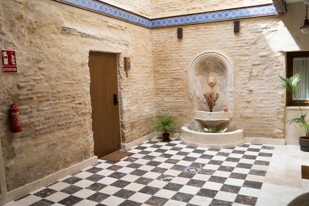 a room with a fountain in the middle of a building at Arena Centro Rooms&Suites, by Homing U in Seville