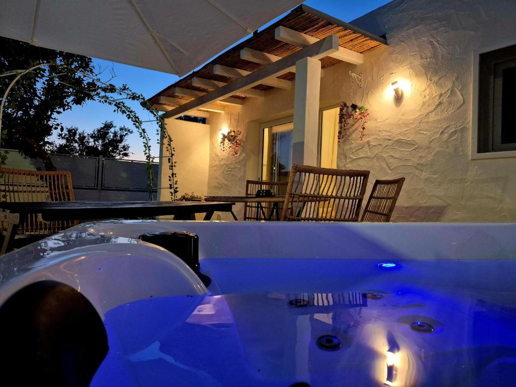 a table in front of a house with lights on it at Romantica Corte dei limoni Piscinas in Piscinas