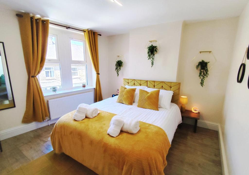 a bedroom with a bed with towels on it at Peak District Cottage in Buxton