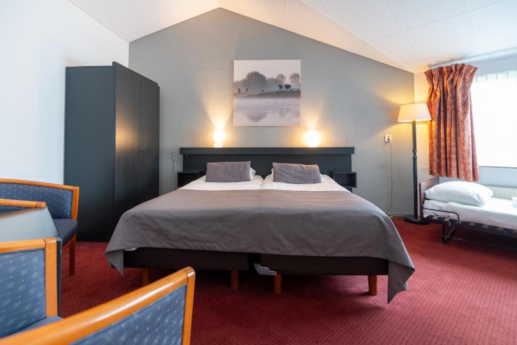 Postel nebo postele na pokoji v ubytování Veluwe Hotel Stakenberg