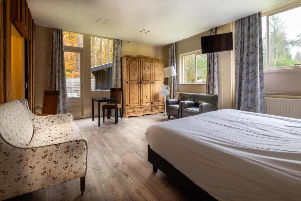 Postel nebo postele na pokoji v ubytování Veluwe Hotel Stakenberg