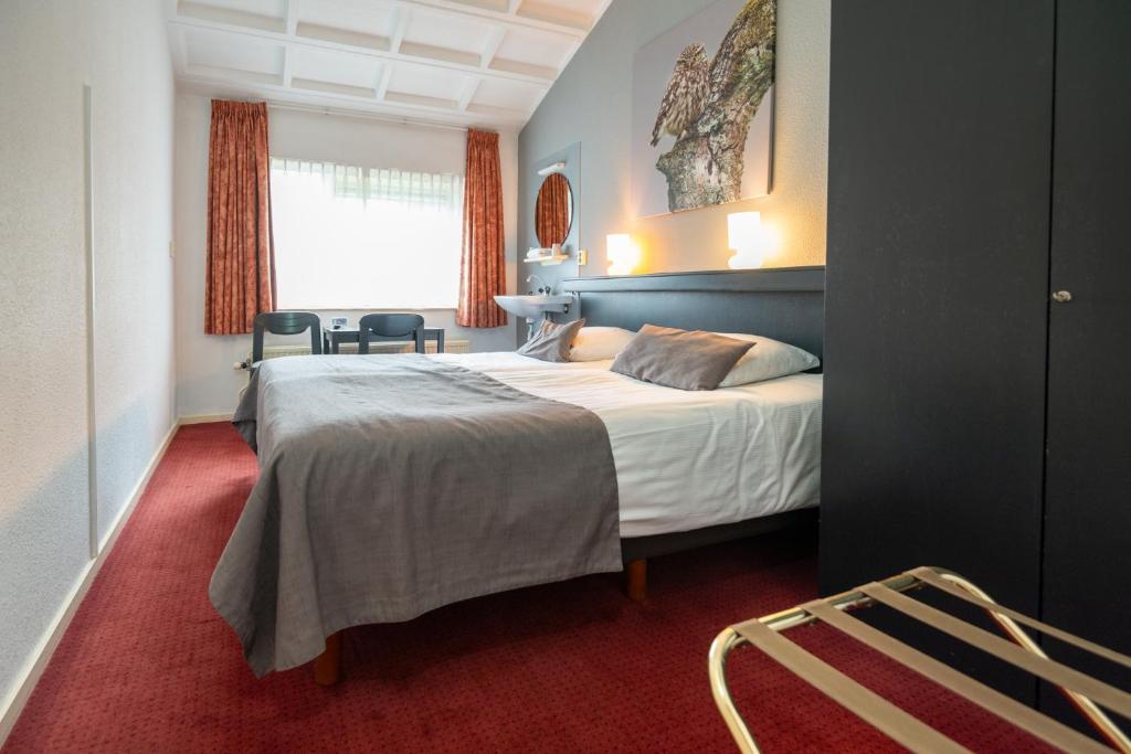 Postel nebo postele na pokoji v ubytování Veluwe Hotel Stakenberg