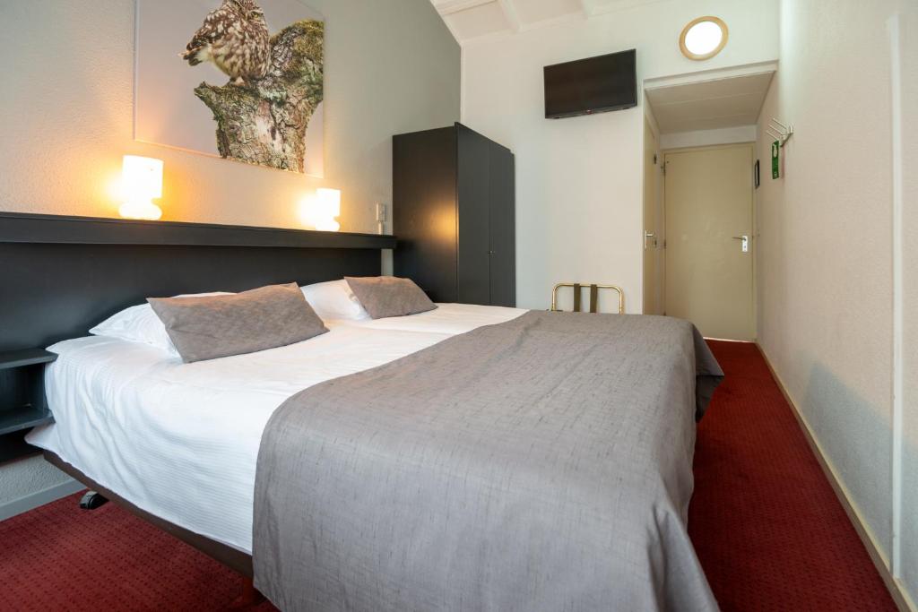 Postel nebo postele na pokoji v ubytování Veluwe Hotel Stakenberg