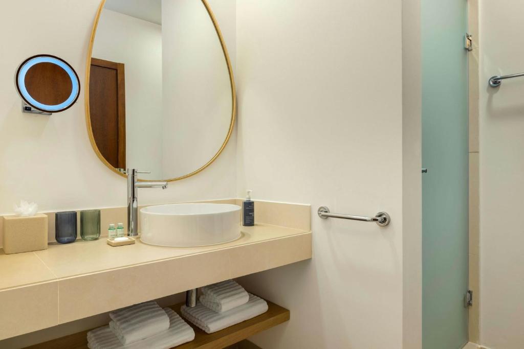 a bathroom with a sink and a mirror at The Westin Salgados Beach Resort, Algarve in Albufeira