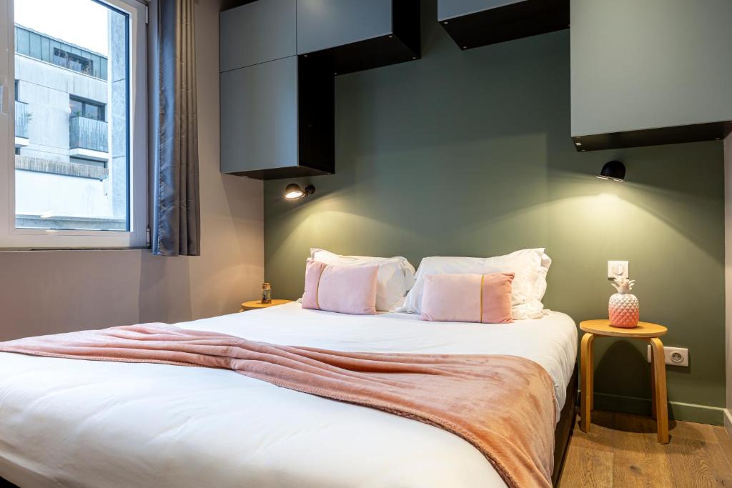 Posteľ alebo postele v izbe v ubytovaní Les Appartements Cardinet
