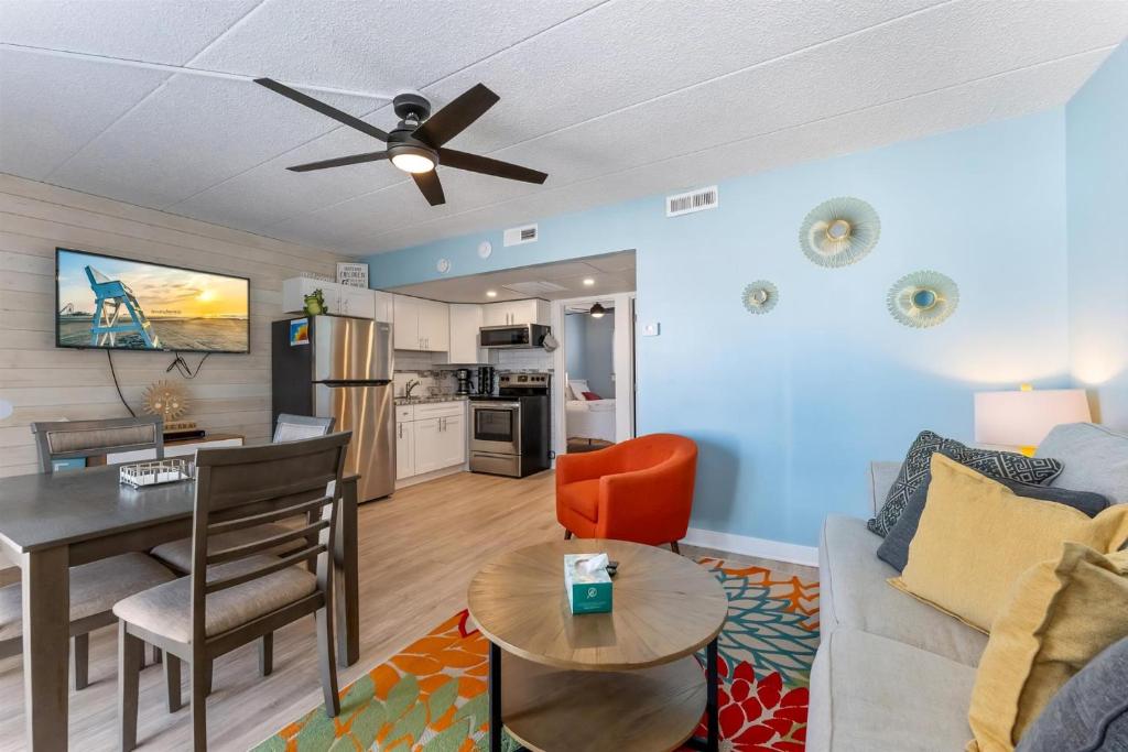 a living room with a couch and a table at 301 Ocean Ave, Unit 316 - The Harbor Light in North Wildwood