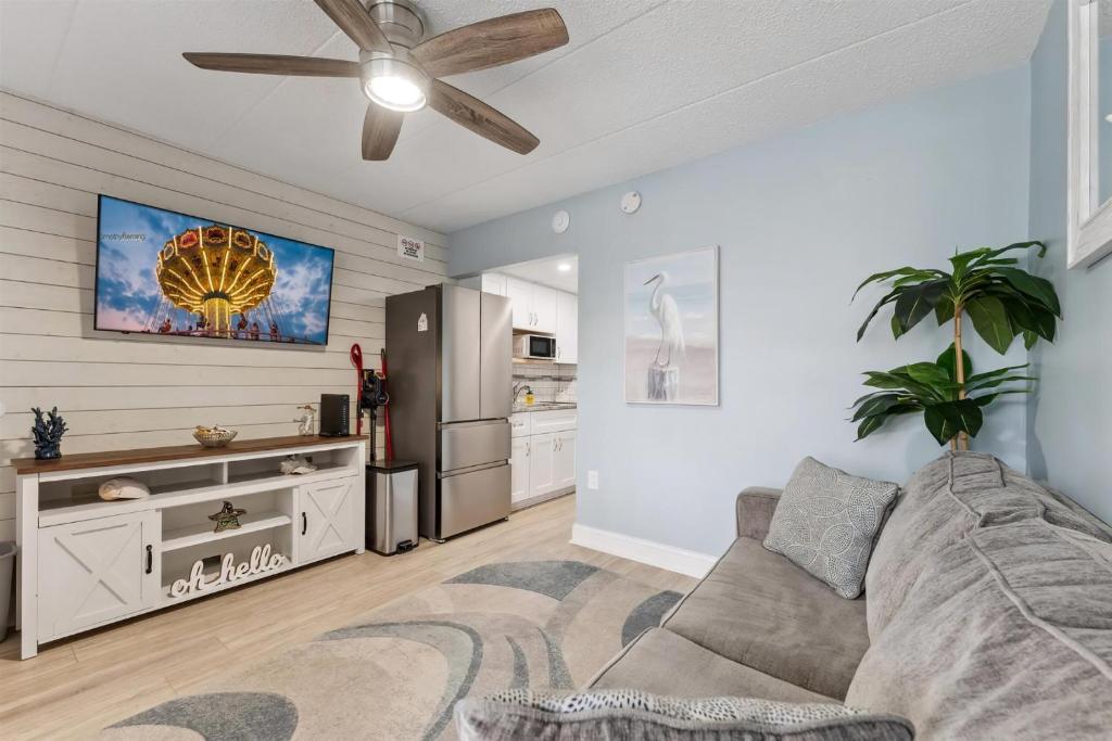 a living room with a couch and a ceiling fan at 301 Ocean Ave, Unit 110 - The Harbor Light in North Wildwood