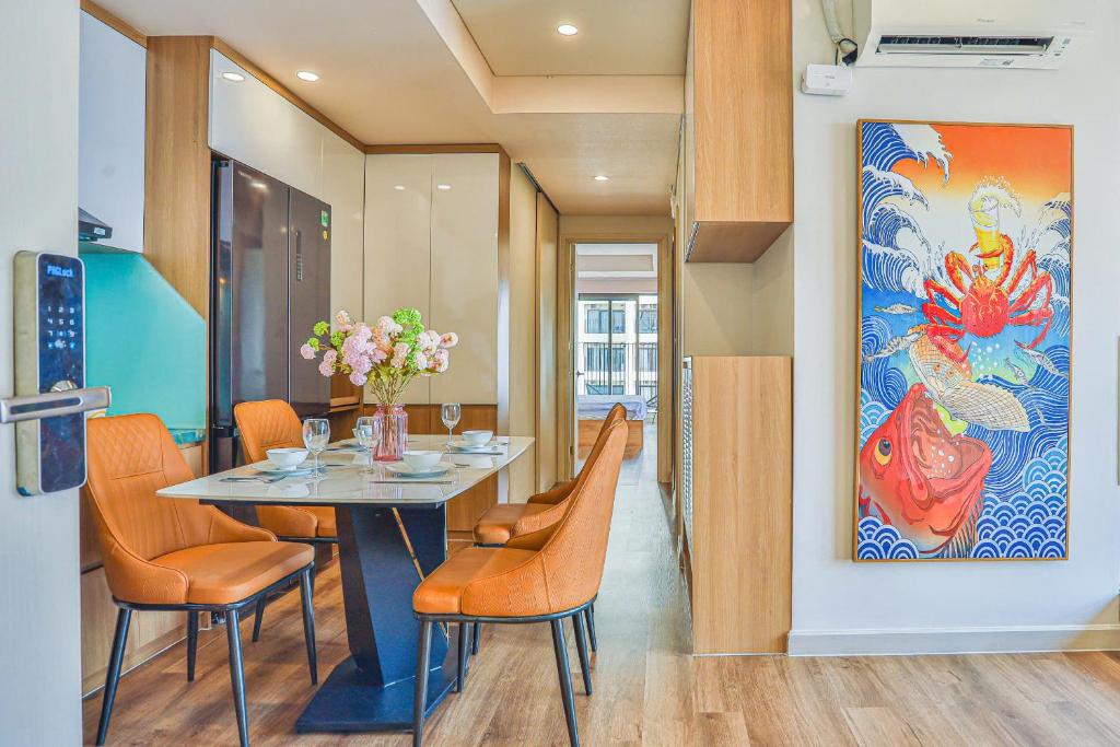 a dining room with a table and chairs and a painting at SeaSky View Suites - Gold Coast Tower, Nha Trang Beach & Lotte Mall in Nha Trang