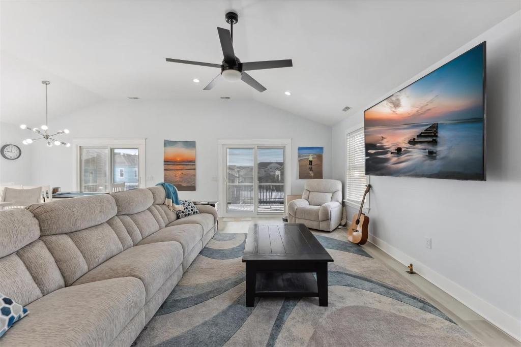 a living room with a couch and a ceiling fan at 225 E Youngs Ave, Unit A in Wildwood