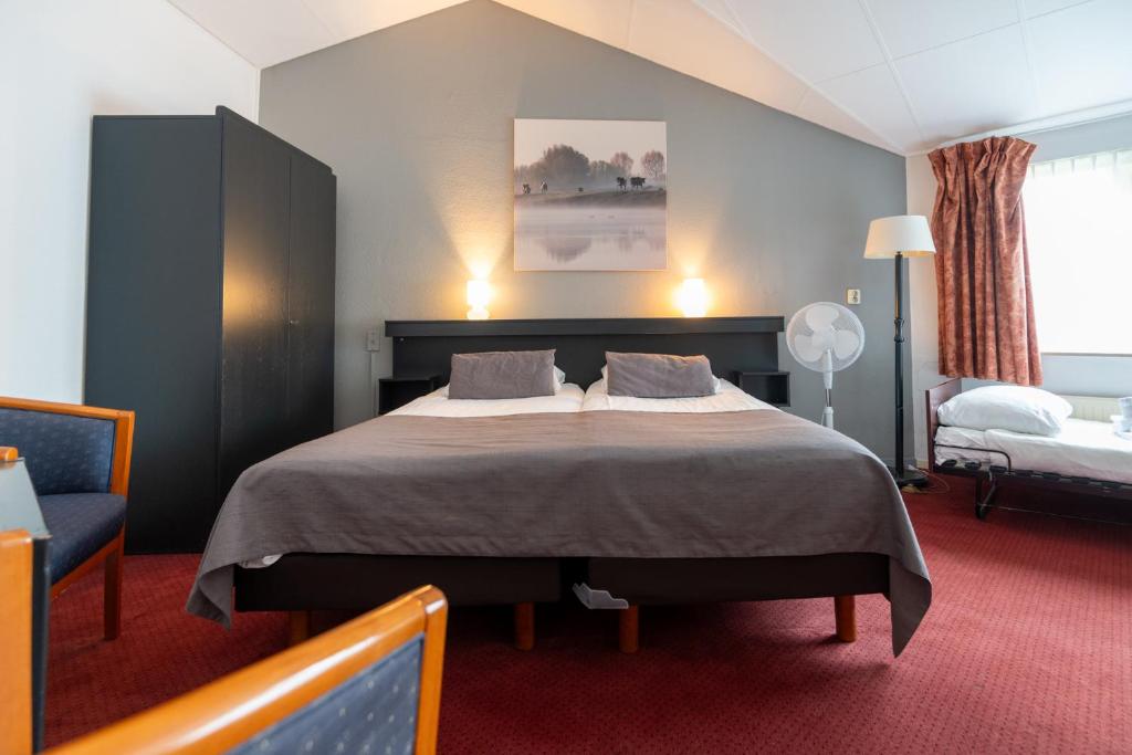 Postel nebo postele na pokoji v ubytování Veluwe Hotel Stakenberg
