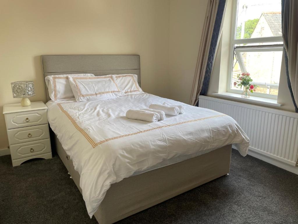 a bedroom with a bed with two towels on it at Ouse River Quay Hill Lodge in Littleport