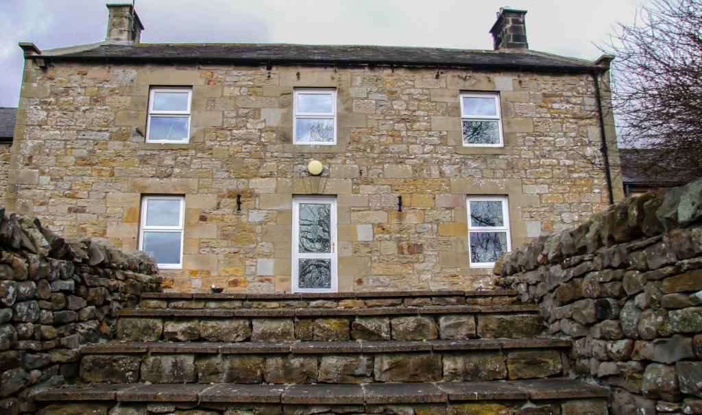 an old stone building with stairs in front of it at Yellow House in West Woodburn