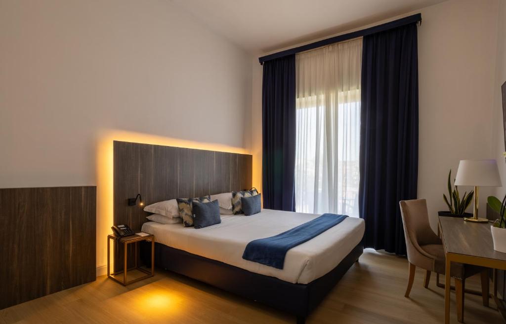 Postel nebo postele na pokoji v ubytování Grand Hotel Tiberio