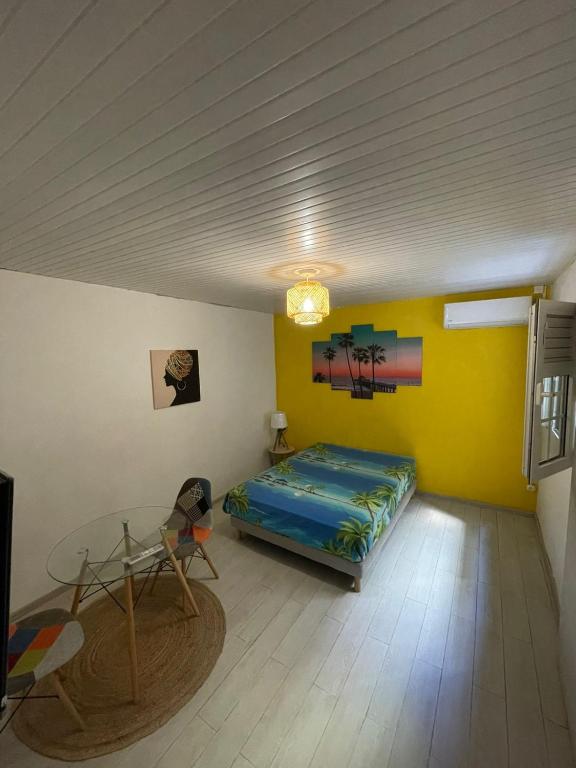 a room with a bed and a table in it at Colibri in Fort-de-France