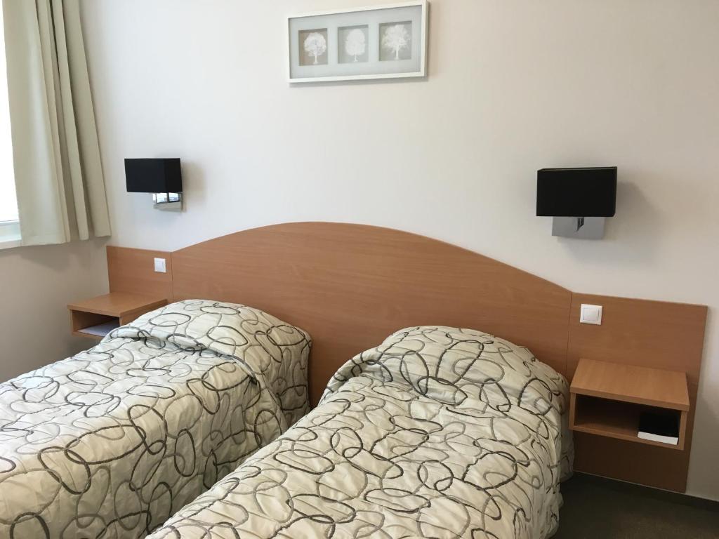 Postel nebo postele na pokoji v ubytování CEU Konferencia Központ
