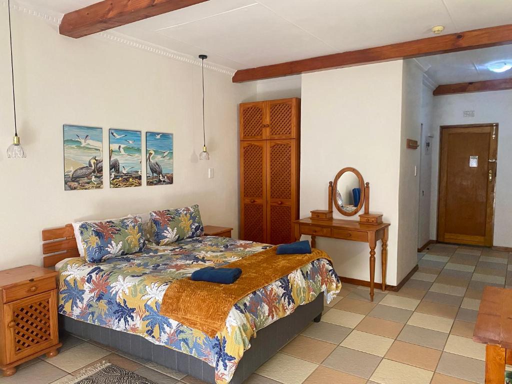a bedroom with a bed and a mirror at Crayfish Inn no7 in Ramsgate