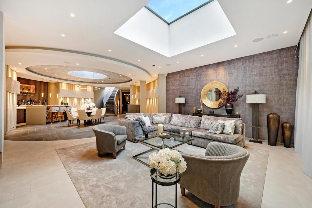 a living room with a couch and a table at Luxurious subterranean mansion - 3 spectacular bedrooms in Altrincham