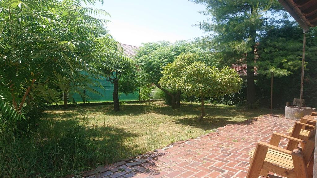 a garden with trees and a brick path at Bernard bnb in Veliko Mlačevo