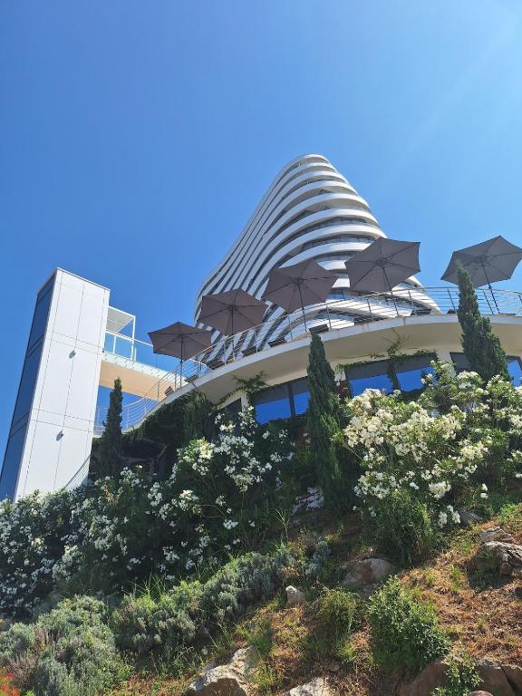 a building with umbrellas in front of it at Skyline sea view apartment in Bečići
